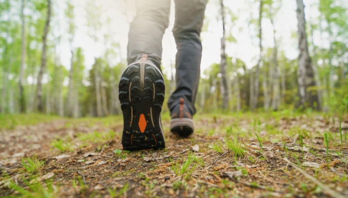 A close-up of a person walking in the woods.